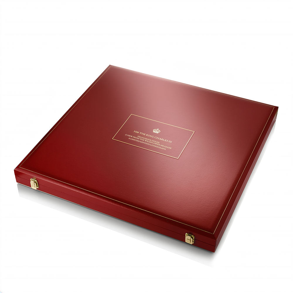 A square red presentation box with gold trim and small gold corner hardware, photographed on a white background.