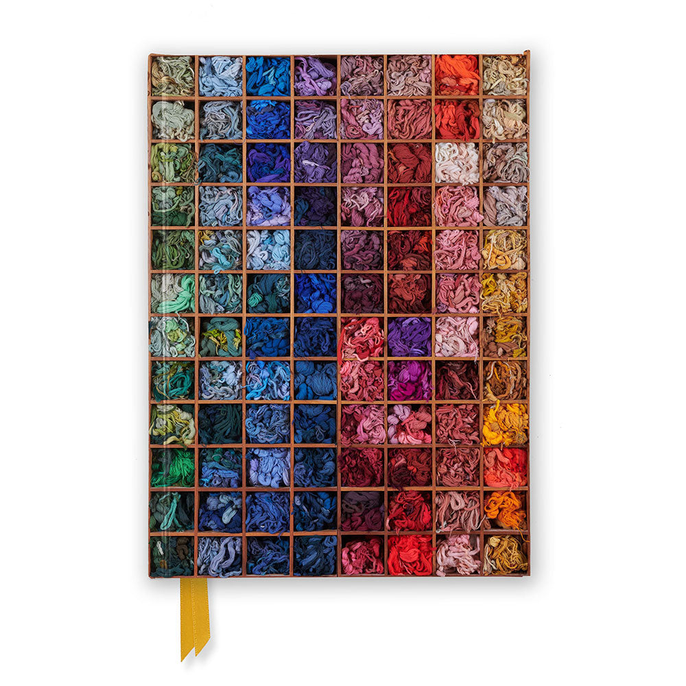 Notebook cover with a grid of colourful yarn squares on a white background
