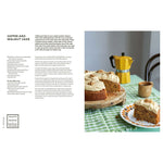 Coffee and walnut cake on a table with a yellow coffee maker and recipe text.