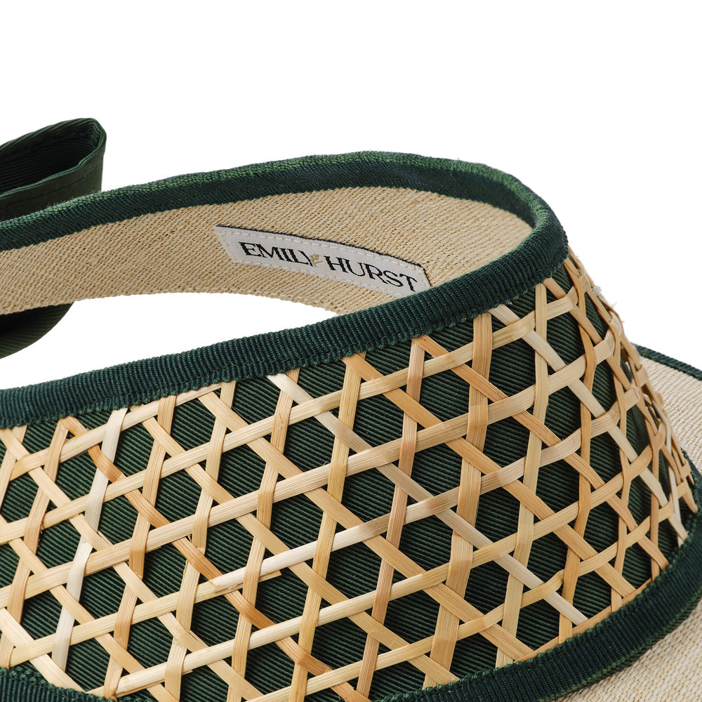 Close-up of a woven visor with green and beige colors and 'EMILY HURST' label.