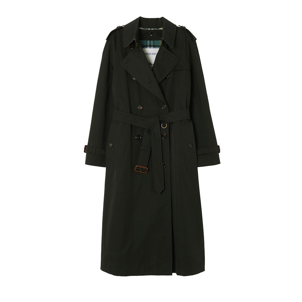A long dark green trench coat with a green and blue plaid lining, displayed flat against a solid white background. A white Burberry brand tag is visible inside the collar.
