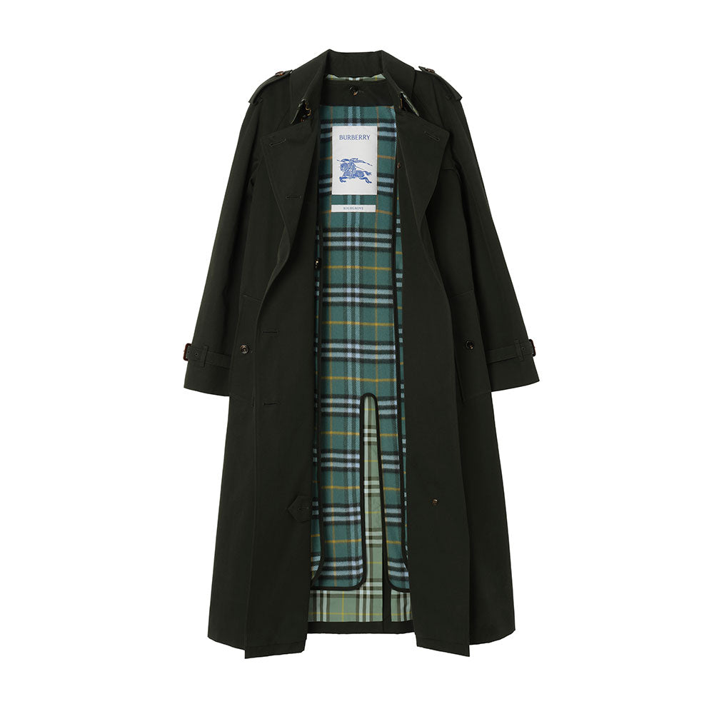 A long dark green trench coat with a green and blue plaid lining, displayed flat against a solid white background. A white Burberry brand tag is visible inside the collar.