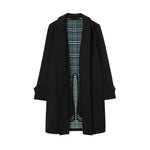 A dark green mid-length trench coat with a green, blue, and beige plaid lining, displayed on a clean white background.