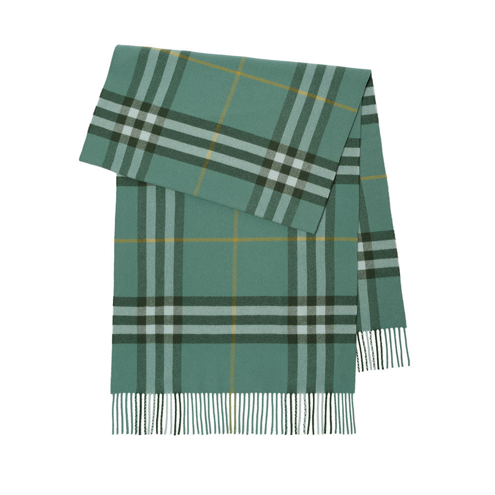 A green plaid scarf with fringe at the bottom, featuring intersecting stripes of dark green, light gray, and thin yellow lines, shown flat against a white background.