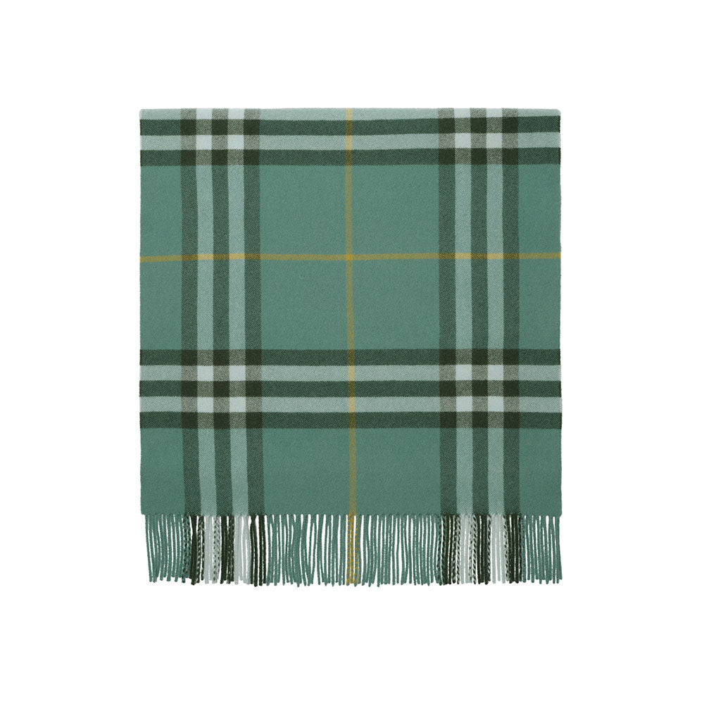 A green plaid scarf with fringe at the bottom, featuring intersecting stripes of dark green, light gray, and thin yellow lines, shown flat against a white background.