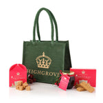 Green tote bag with 'Highgrove' branding, Christmas-themed products including a jar and box, on a white background.