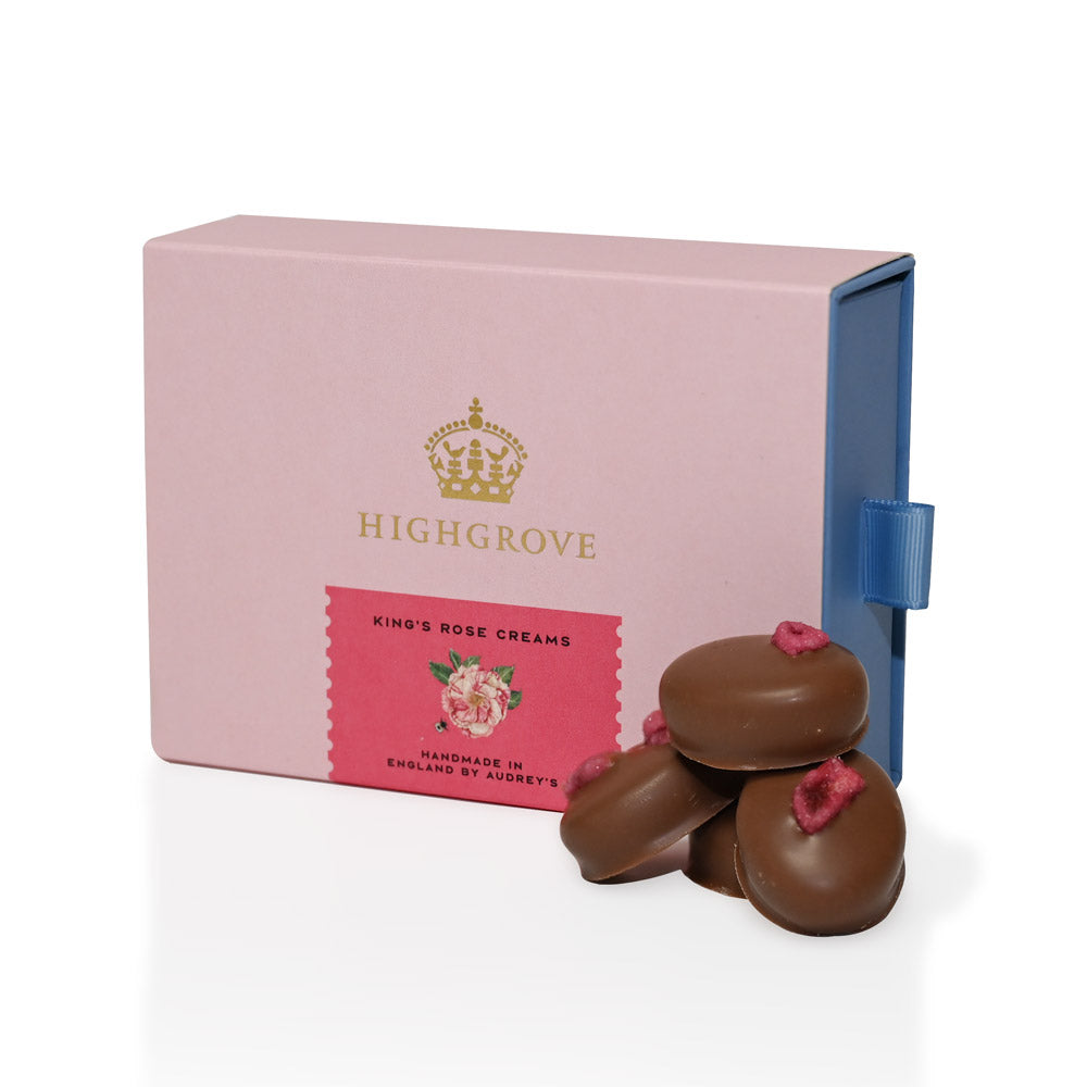 Pink Highgrove box with King's Rose chocolate creams on a white background