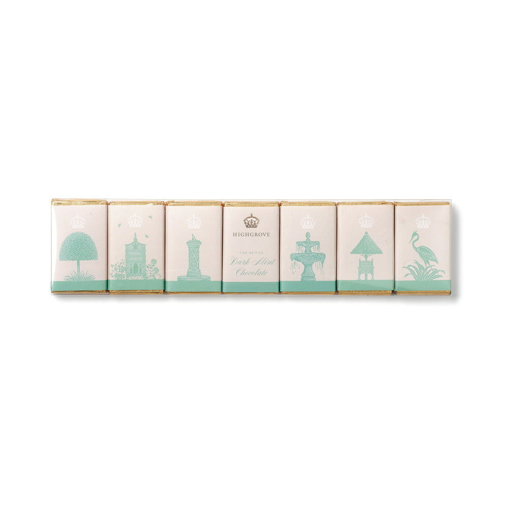Six individually wrapped Dark Mint Chocolates arranged in a row on a clean white background. The wrappers are a soft blush pink with mint green illustrations of Highgrove Garden landmarks and gold foil borders.