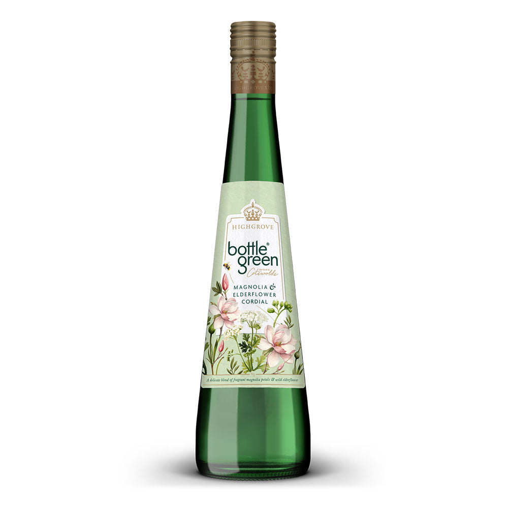 A bottle of Highgrove x bottlegreen magnolia and elderflower cordial, featuring a green glass bottle with a light green label decorated with pink flowers, topped with a gold screw cap, set against a plain white background.