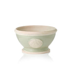 Green ceramic footed bowl plant pot with a beige rim and Highgrove logo on a white background