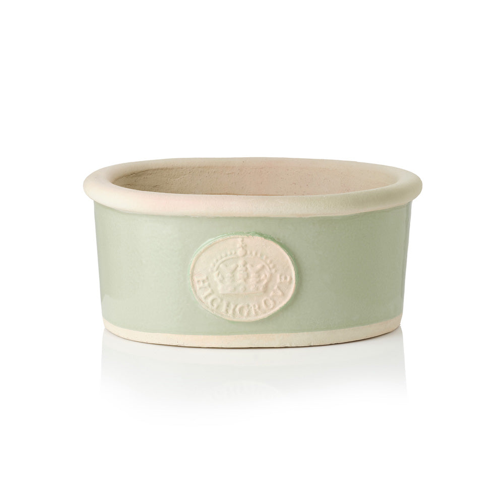 Green ceramic bowl plant pot with beige rim and Highgrove Crown logo on a white background