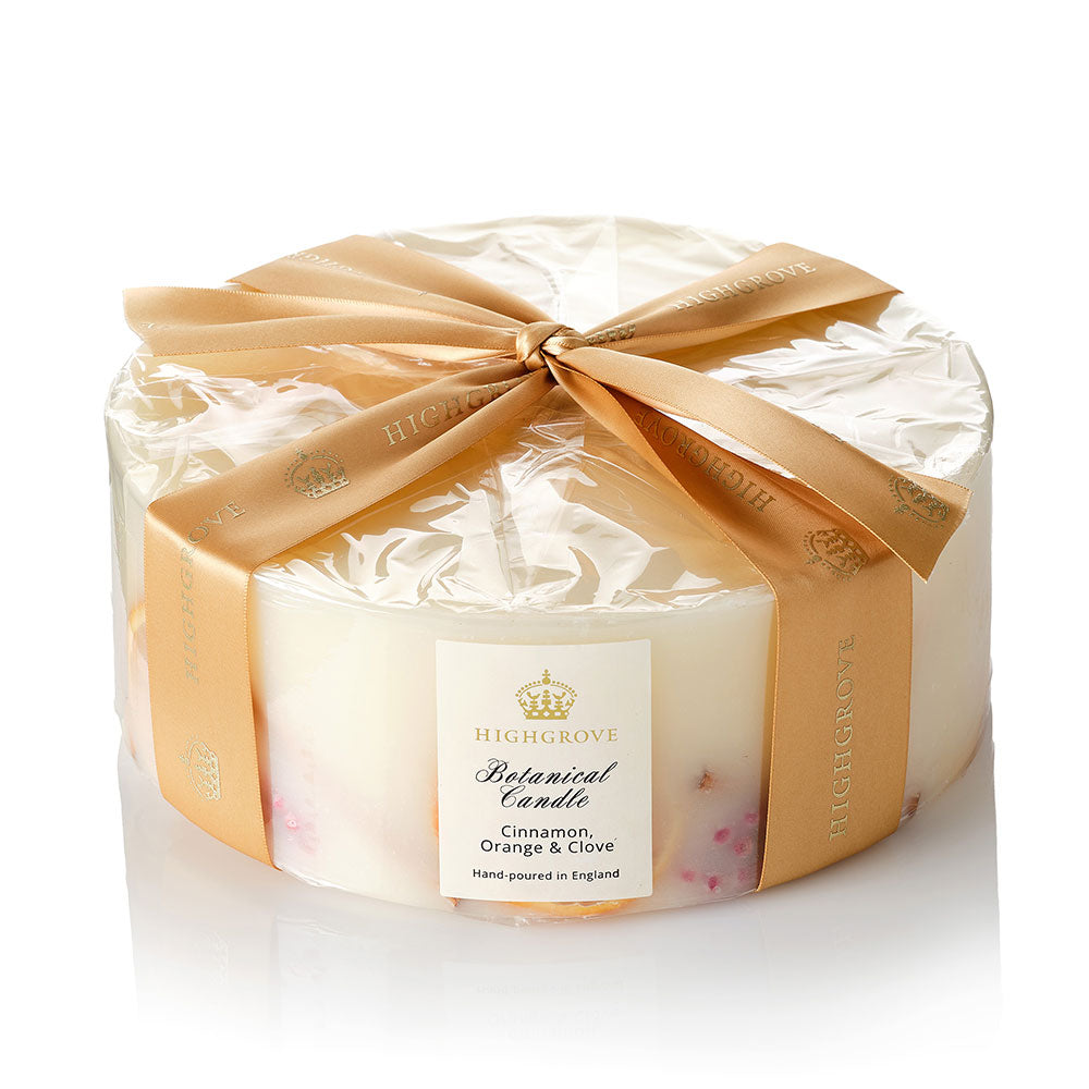 Decorative five wick candle with a gold bow and 'Highgrove' branding on a white background