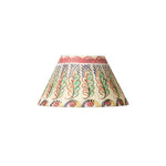 A decorative lampshade with a cream-colored base and a hand-painted folk art pattern featuring green, pink, red, and black motifs, isolated on a white background.