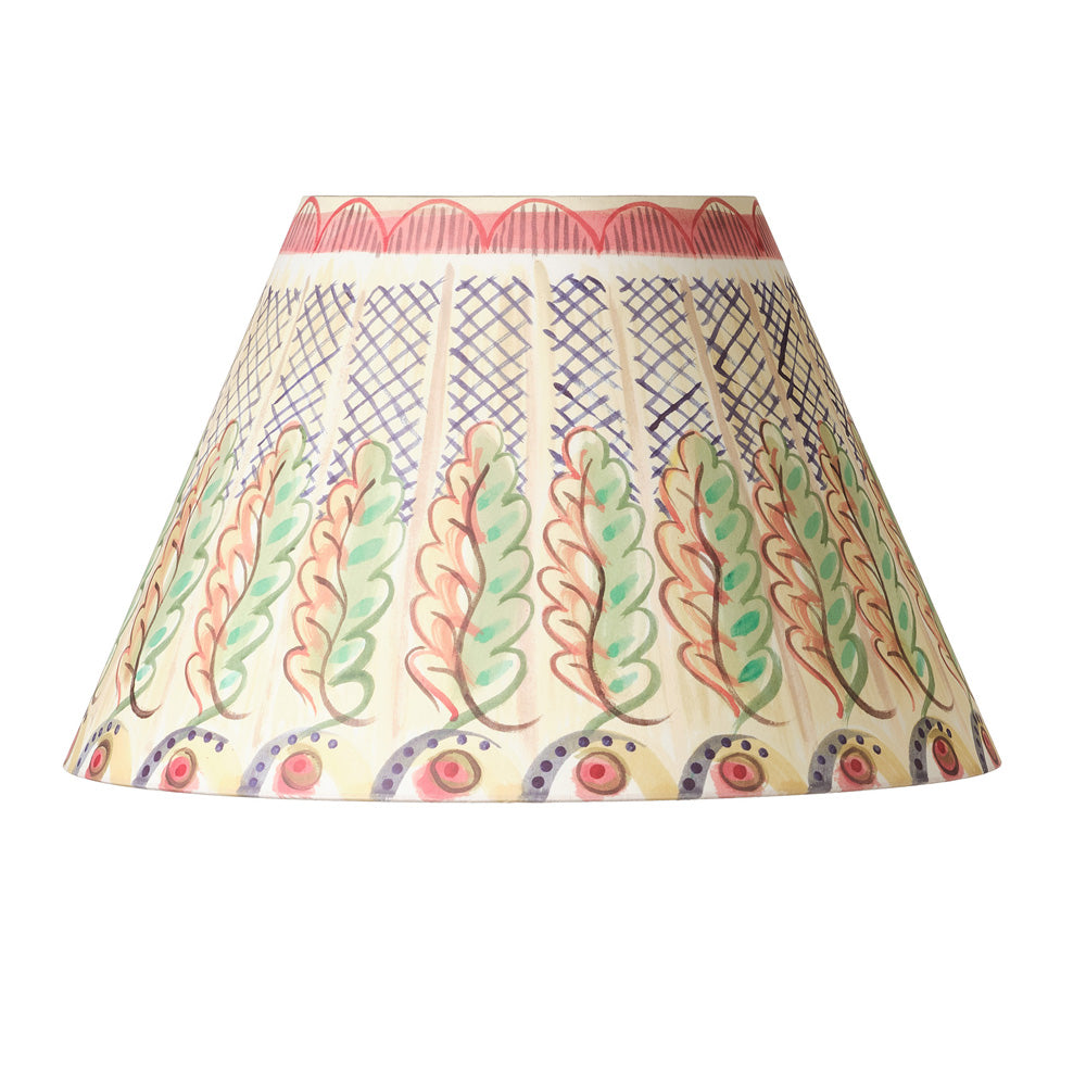 A conical fabric lampshade featuring a hand-painted folk art pattern with stylized leaves in green, red, and blue on a cream background, complete with a red patterned inner band.