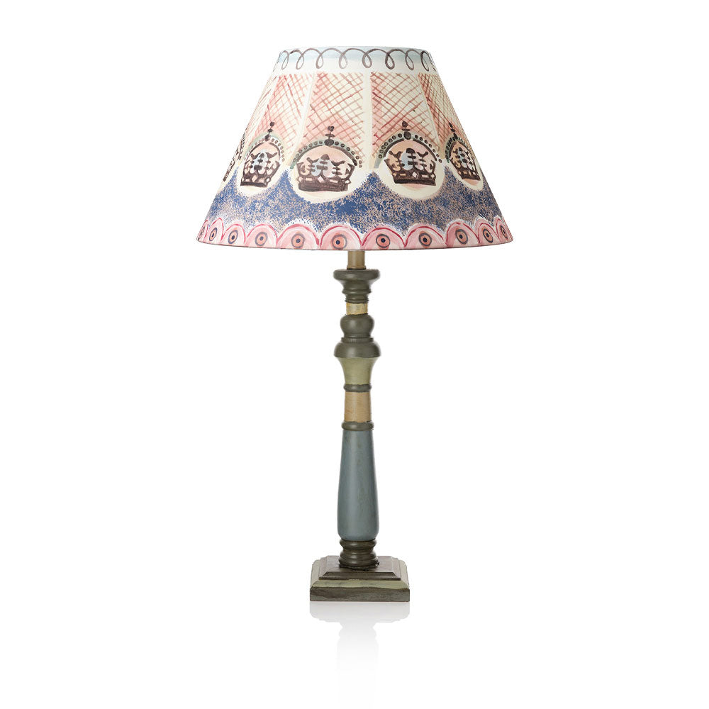 Decorative table lamp with a patterned shade on a white background