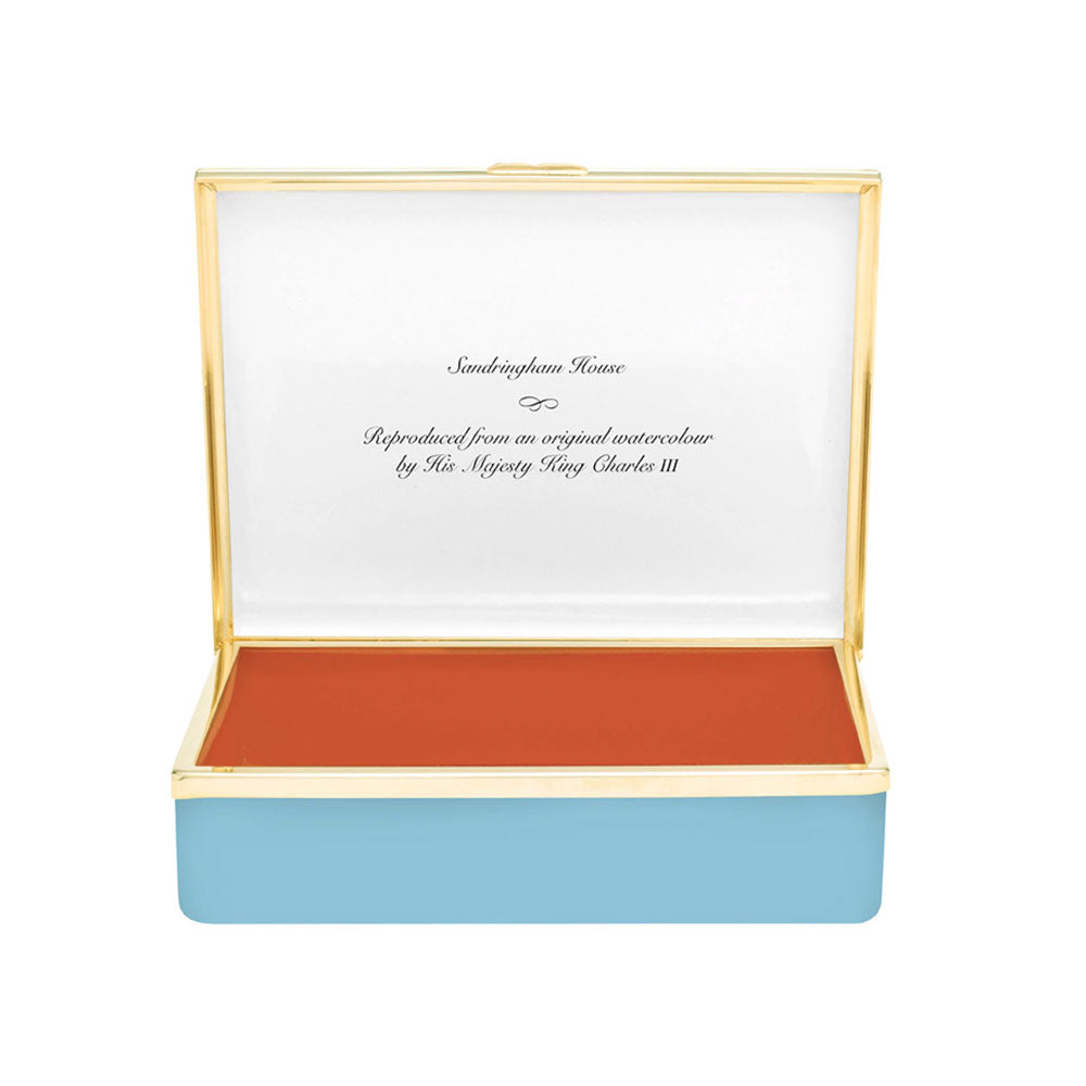 Inside of enamel leather-lined box with writing that reads "Reproduced from an original watercolour by His Majesty King Charles III"