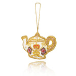 A decorative teapot-shaped hanging ornament with a gold wire frame, white enamel body, a red crown, and Union Jack flags on a clean white background.