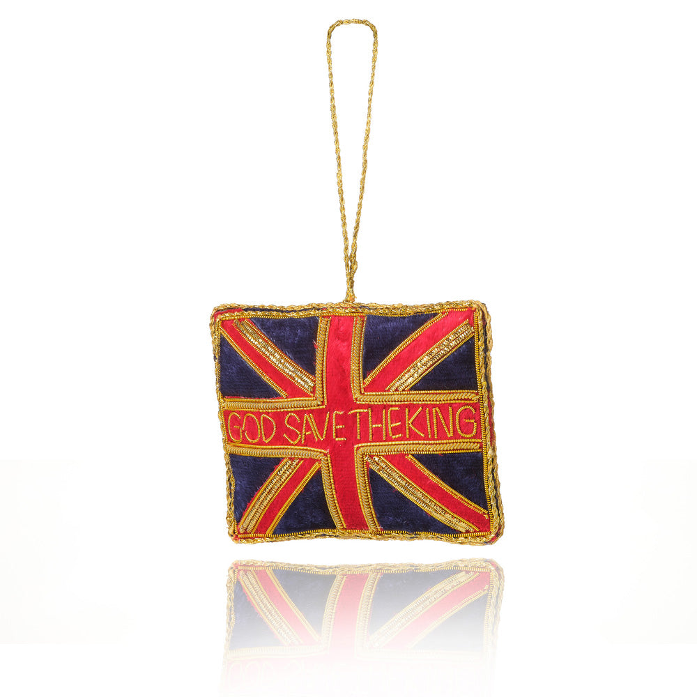 A square decorative ornament featuring a Union Jack design with the text 'GOD SAVE THE KING' in red across the centre, finished with gold trim and a hanging loop at the top, shown on a white background with a soft reflection below.