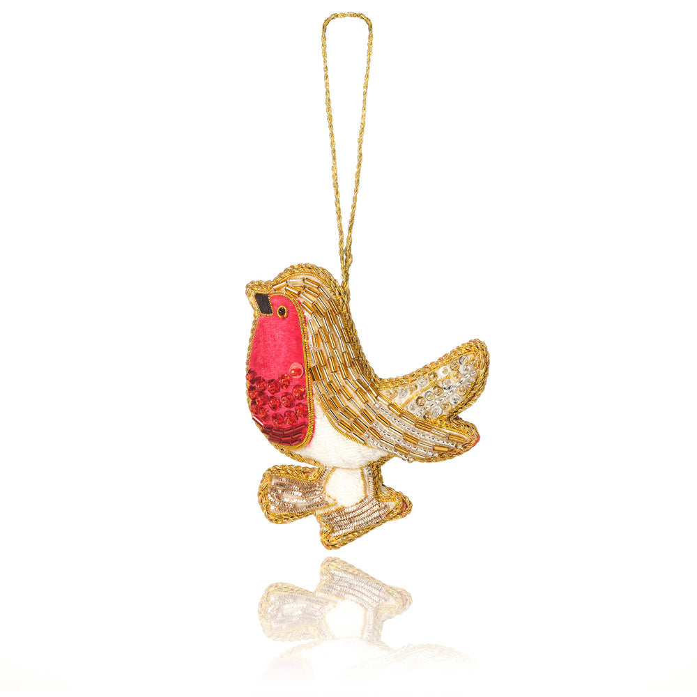 A decorative robin ornament with a gold glitter body, a bright red chest, and white underparts, hanging from a thin gold string against a white background.