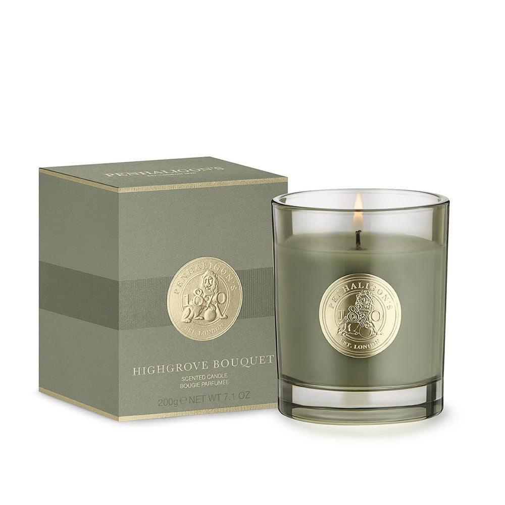 Green candle with gold emblem and matching box on a white background
