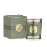 Green candle with gold emblem and matching box on a white background