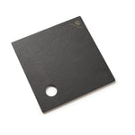 A square black slate serving board with a circular cutout near one corner and a small gold crown logo with the brand name 'HIGHGROVE' printed in the top right, shown on a clean white background.