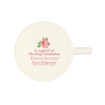 White mug with floral design and text on a white background