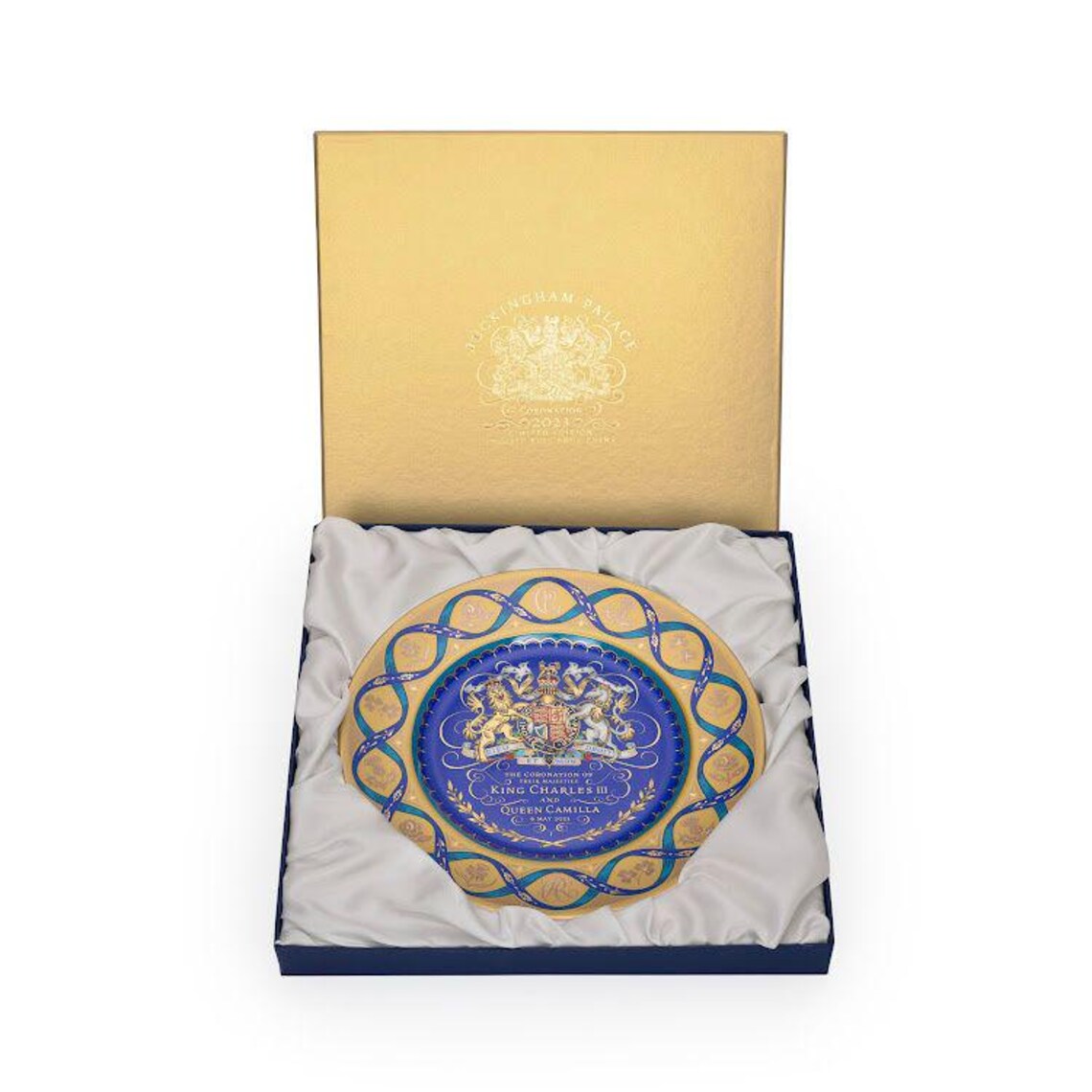 Decorative plate with a blue and gold design in a matching box on a white background