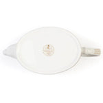 White ceramic teapot with coronation emblem on a white background