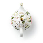Decorative teapot with The King's Rose floral and insect design on a white background