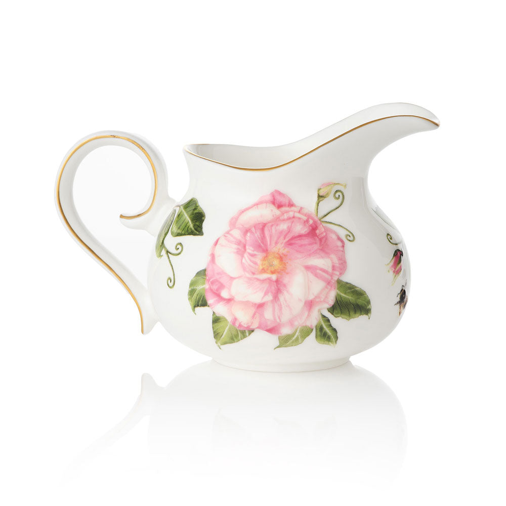 White ceramic creamer jug with The King's Rose floral design on a white background