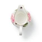 Inside of white ceramic creamer jug with The King's Rose floral and insect bee design on a white background