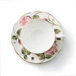 Inside of teacup and saucer with The King's Rose floral design on a white background