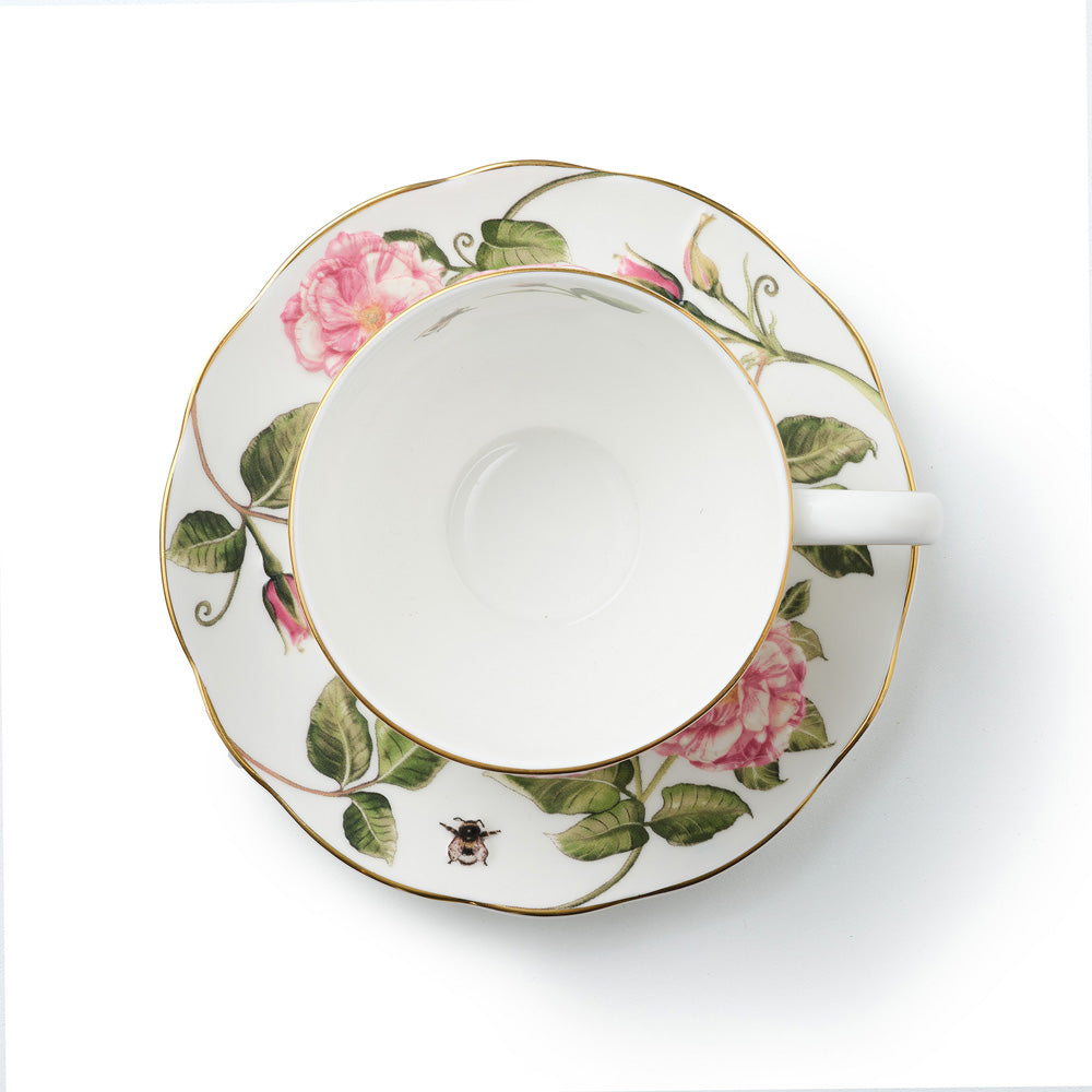 Inside of teacup and saucer with The King's Rose floral design on a white background