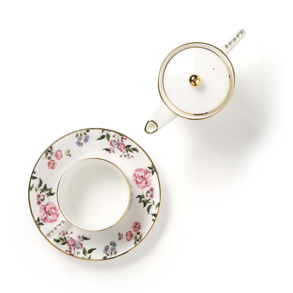 Fine bone china teacup with The King's Rose floral design and matching saucer on a white background