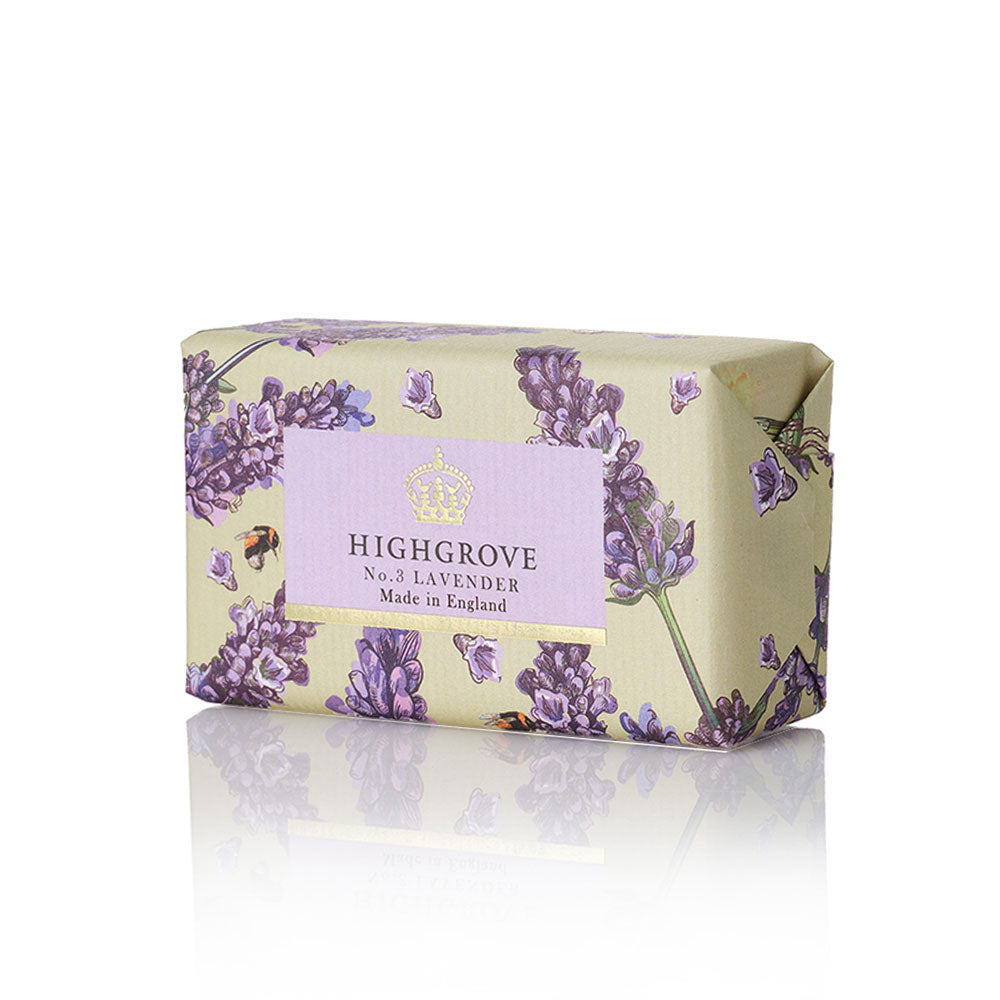 Highgrove No.5 Lavender soap bar wrapped in a pale yellow-green paper with a purple lavender floral pattern and a central lavender label, shown on a white background with a soft reflection.