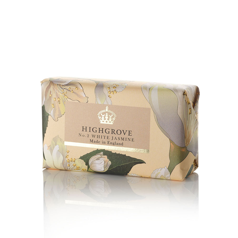 Highgrove No. 2 White Jasmine soap bar wrapped in beige floral paper packaging with white jasmine blossoms and green leaves, featuring a central label with a crown logo and the brand name Highgrove.