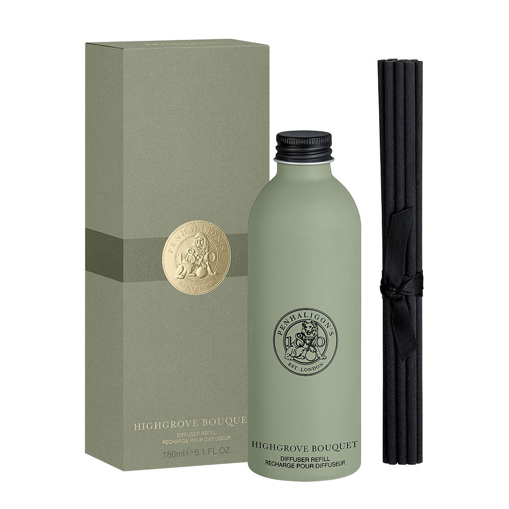 A diffuser bottle in muted sage green stands beside its matching box and a bundle of black reeds on a clean white background. The bottle and box both show the Highgrove Bouquet branding and a gold circular seal.