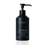 A matte black pump bottle of Olverum Soothing Hand Lotion on a clean white background.