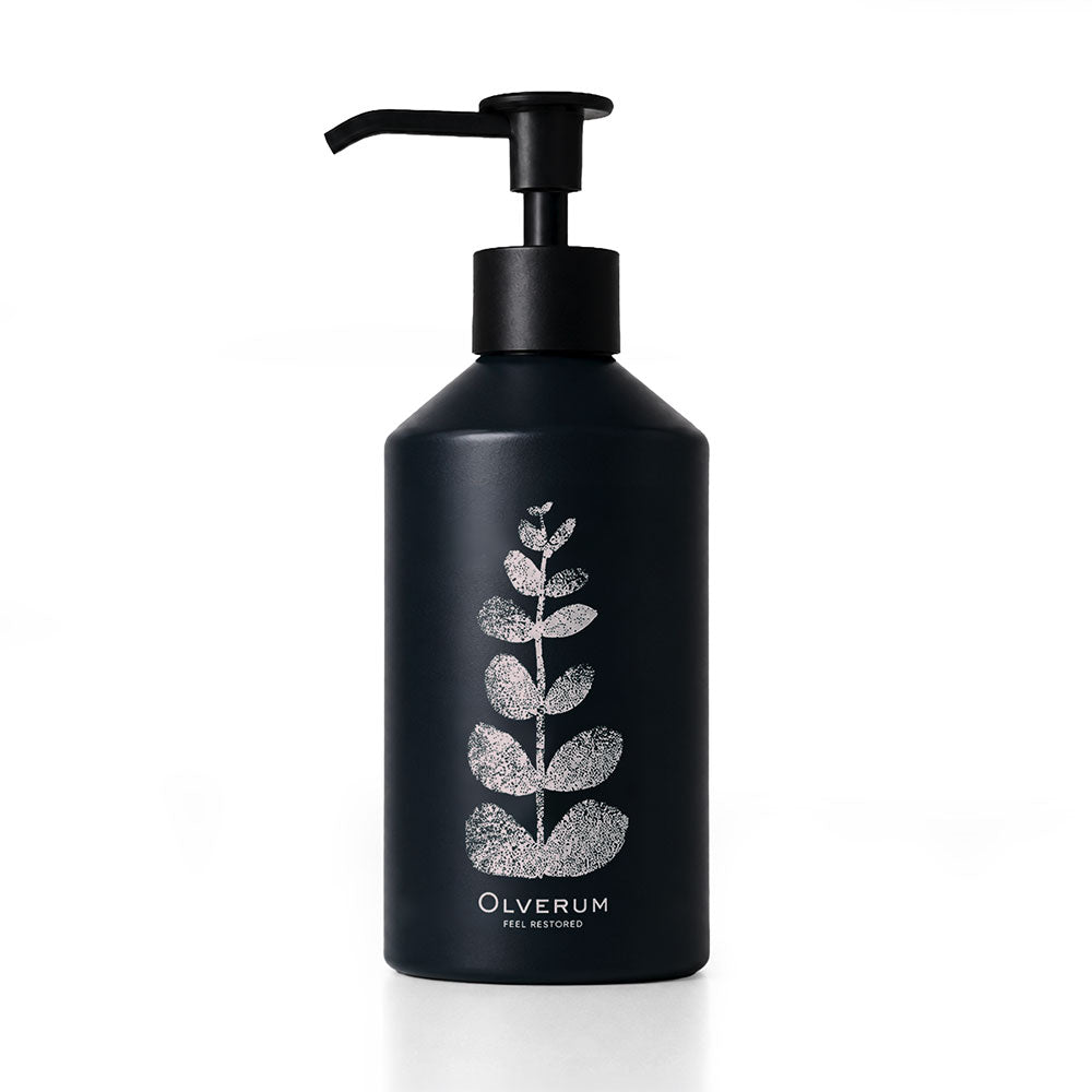 A matte black pump bottle with a silver glittery leaf design and the brand name 'OLVERUM' printed in white at the bottom, set against a clean white background.