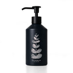 A matte black pump bottle with a silver glittery leaf design and the brand name 'OLVERUM' printed in white at the bottom, set against a clean white background.